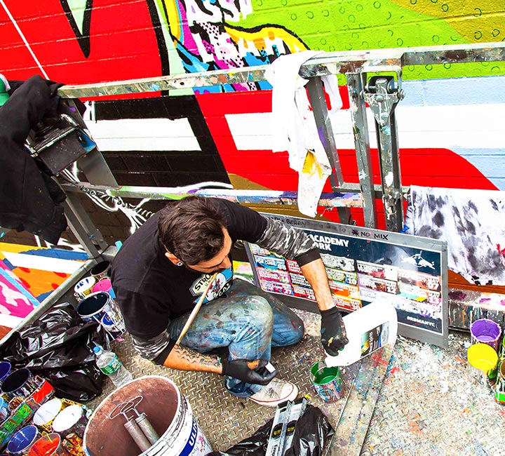 Colossal painter working on an RBMA mural