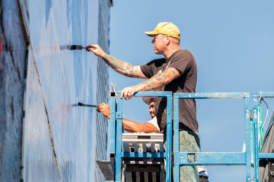 Jason Coatney painting a mural for 2K Games in Brooklyn