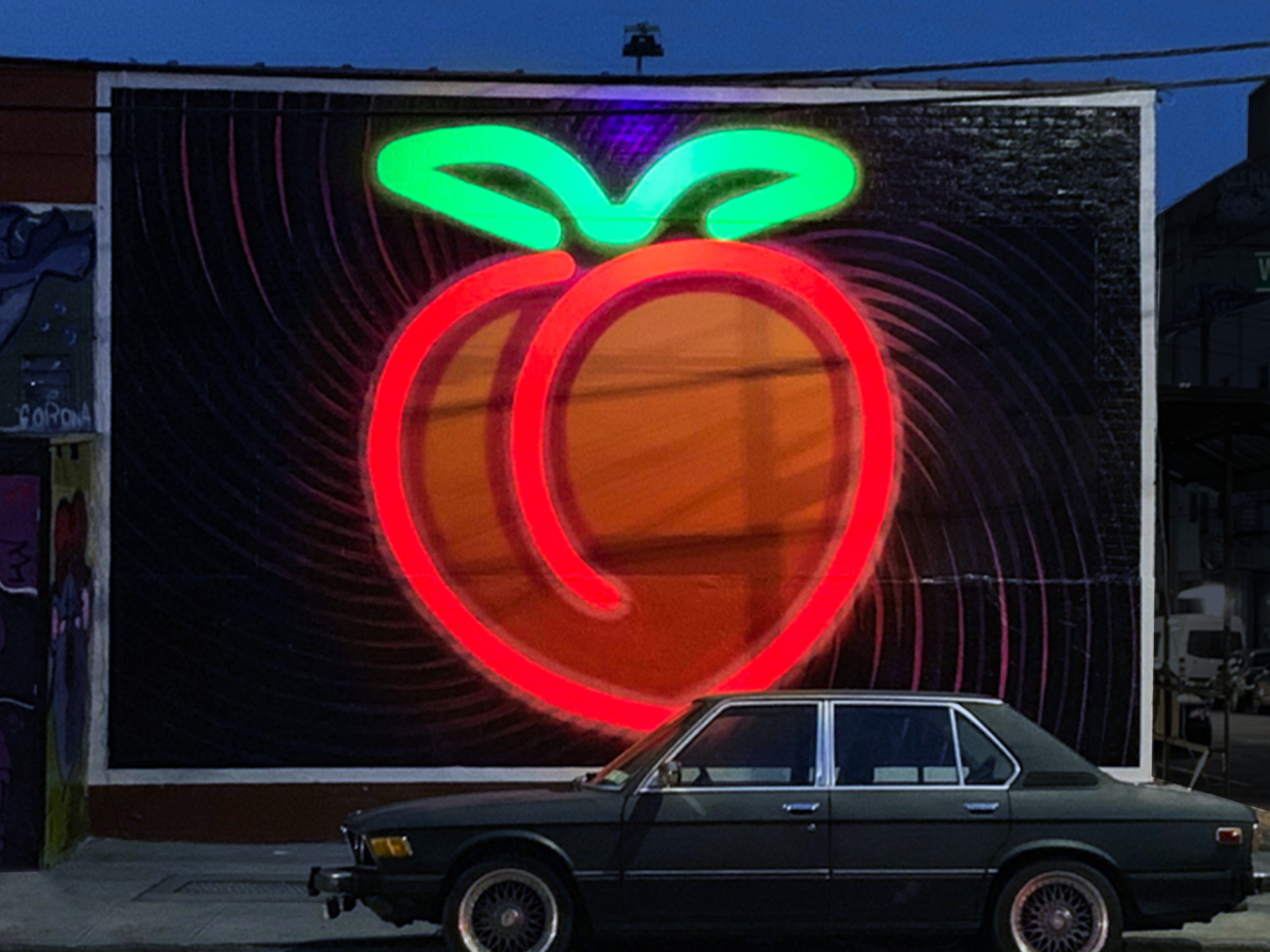 Glowing peach mural painted by Colossal