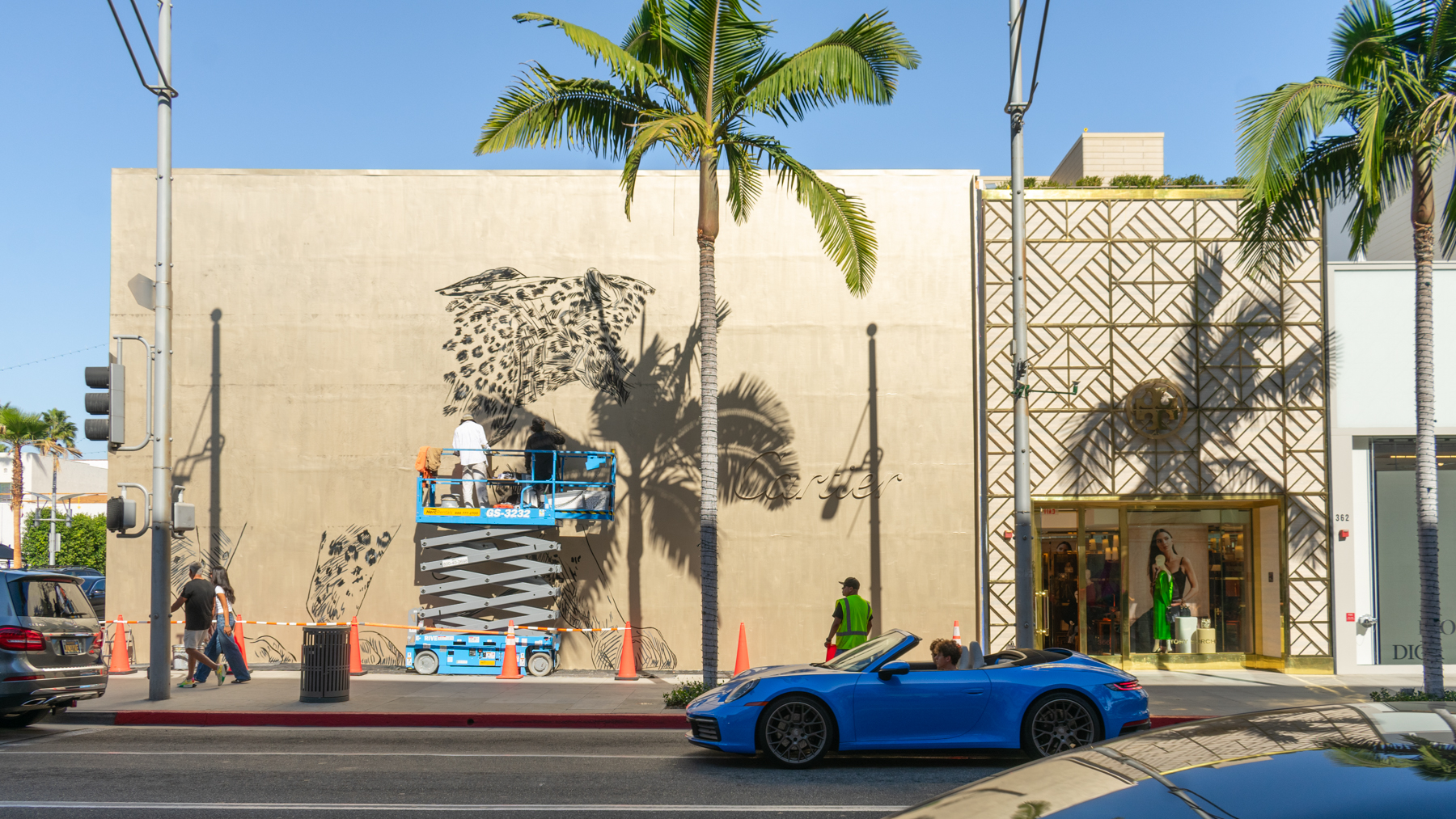 Painting progress photos of a Colossal Media hand-painted mural of the Cartier Gold Panthère for Cartier in the City of Beverly Hills.